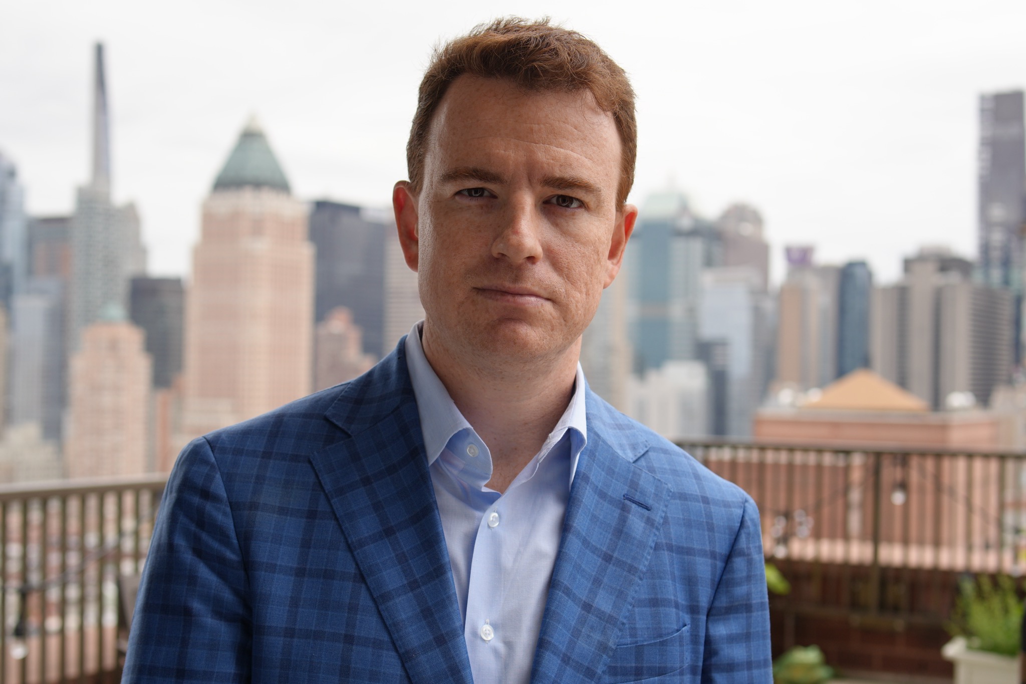 James Tannahill outdoors in New York City, private equity executive and founder, smiling in a casual setting